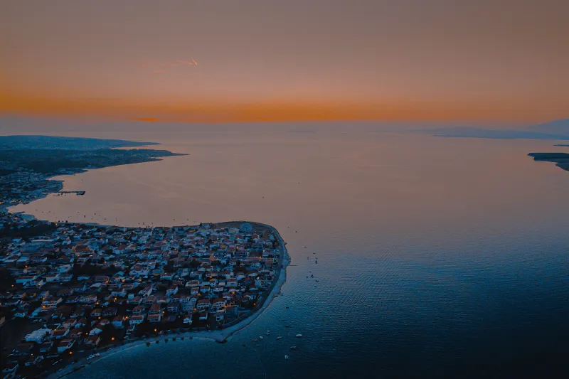 Vir apartments – aerial evening panorama of the island settlement and bay illuminated by the glow of dusk.